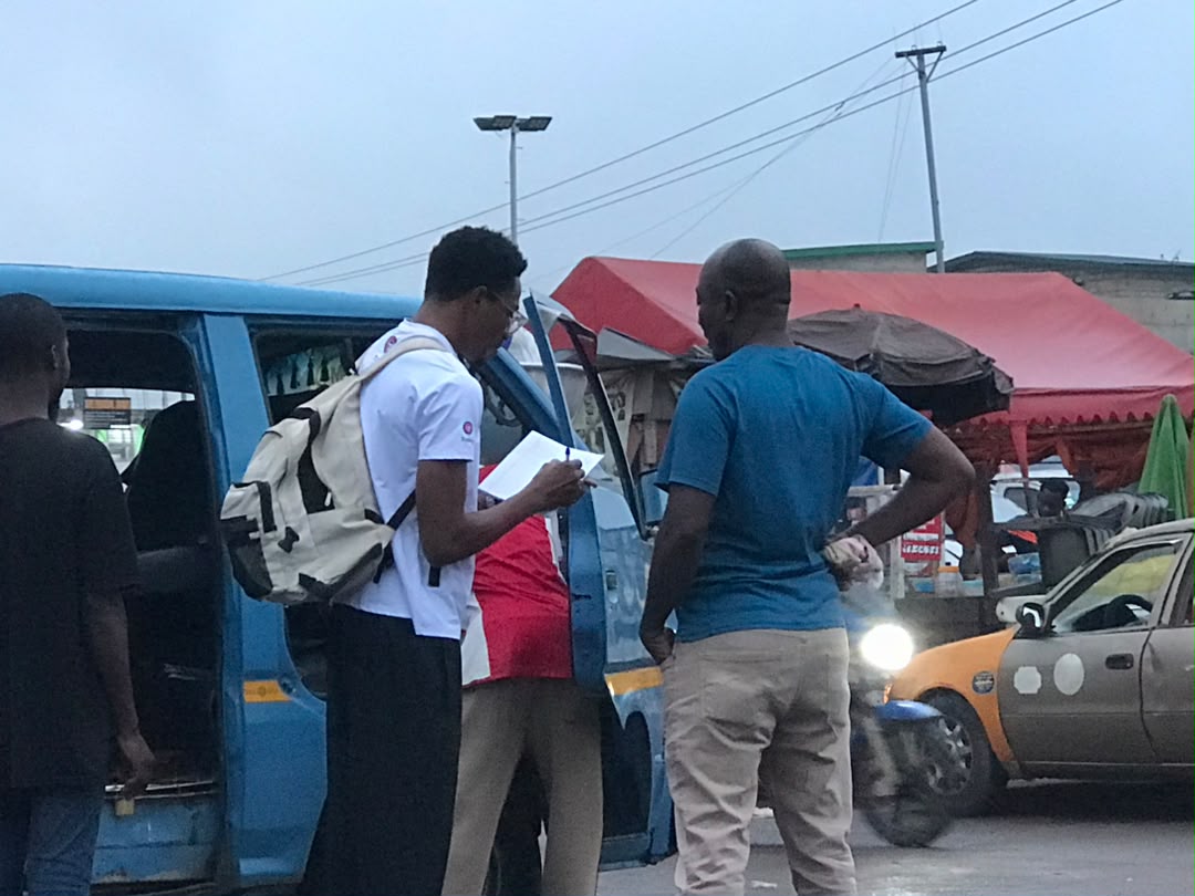 Team talking with a driver mid-shift at Kaneshie