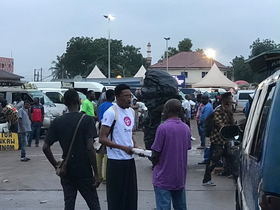 Team talking with trotro drivers at Kaneshie station