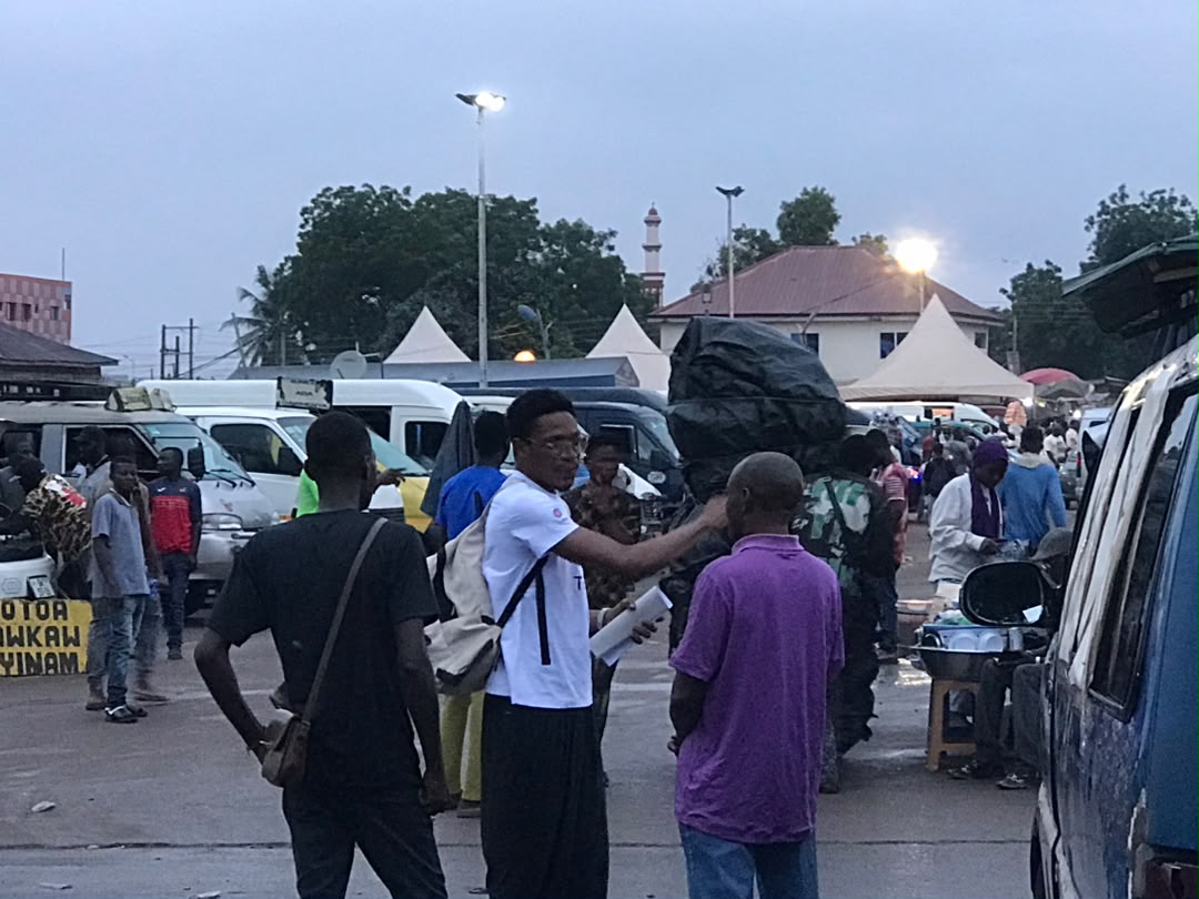 Team talking with a driver during a quiet moment at Kaneshie
