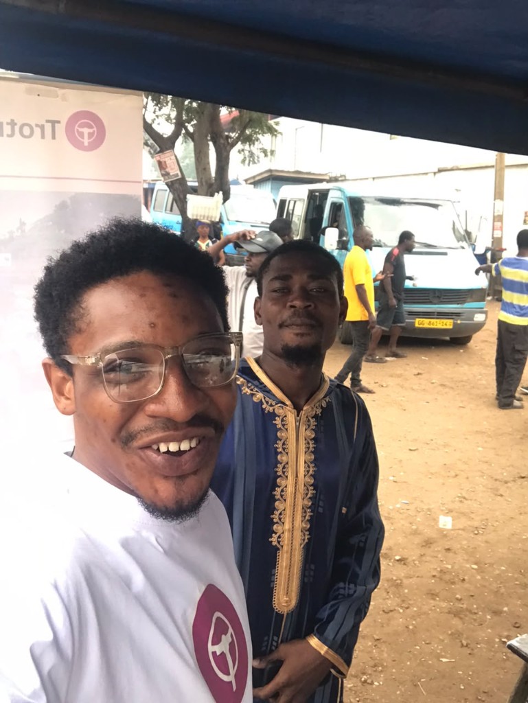 Trotro banner and team on the roadside at a station